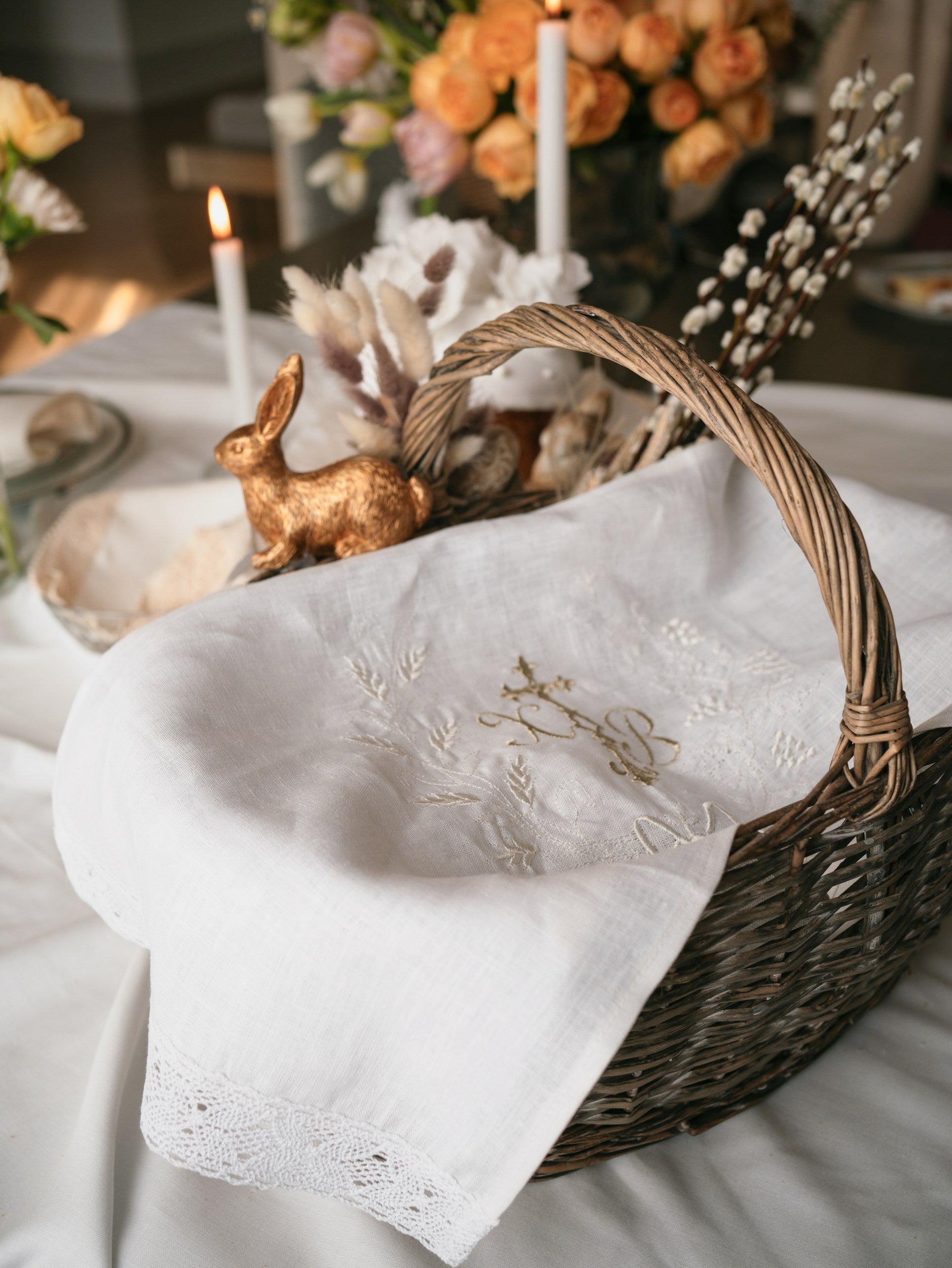 white linen Easter towel with embroidery and lace in basket
